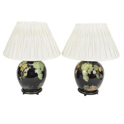 Pair of Jenny Worrall table lamps, of ovoid form, the glass body decorated with fruit and trailing flowers upon a black ground with gilt flecks, with pleated cream lampshades, including shades H65cm