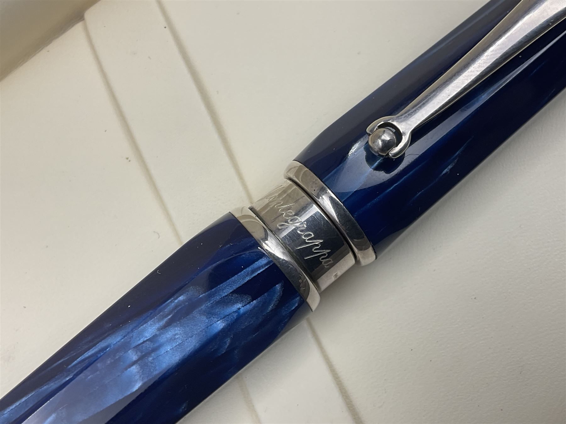 Montegrappa Emblema fountain pen, the blue pearl marbled barrel of octagonal form with silver mounts stamped 925 and silver mounted cap with 1912 emblem and clip with roller, in box, L13.5cm