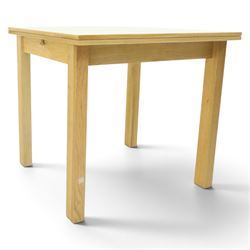 Contemporary light oak extending dining table, the square top with pull-out and fold-over action, raised on square supports