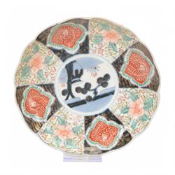 Group of 19th century Japanese Imari porcelain, Meiji period, comprising pair of lobed dishes, decorated stylised reserves and painels in blue and gilt upon a red ground, H6.5cm D21.5cm, a pair of plates of circular lobed form, decorated with a central panel depicting a vase beneath pine branches, and surrounded by panels of flowers and stylised quatrefoil shapes, D21cm, and another similar example painted with a character in underglaze blue to the centre, with character mark beneath, D22cm, each with character marks beneath               