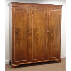  Early 20th century walnut triple wardrobe, projecting cornice, fitted with hanging rail and three linen slides, shaped bracket feet, W173cm, H200cm, D53cm  