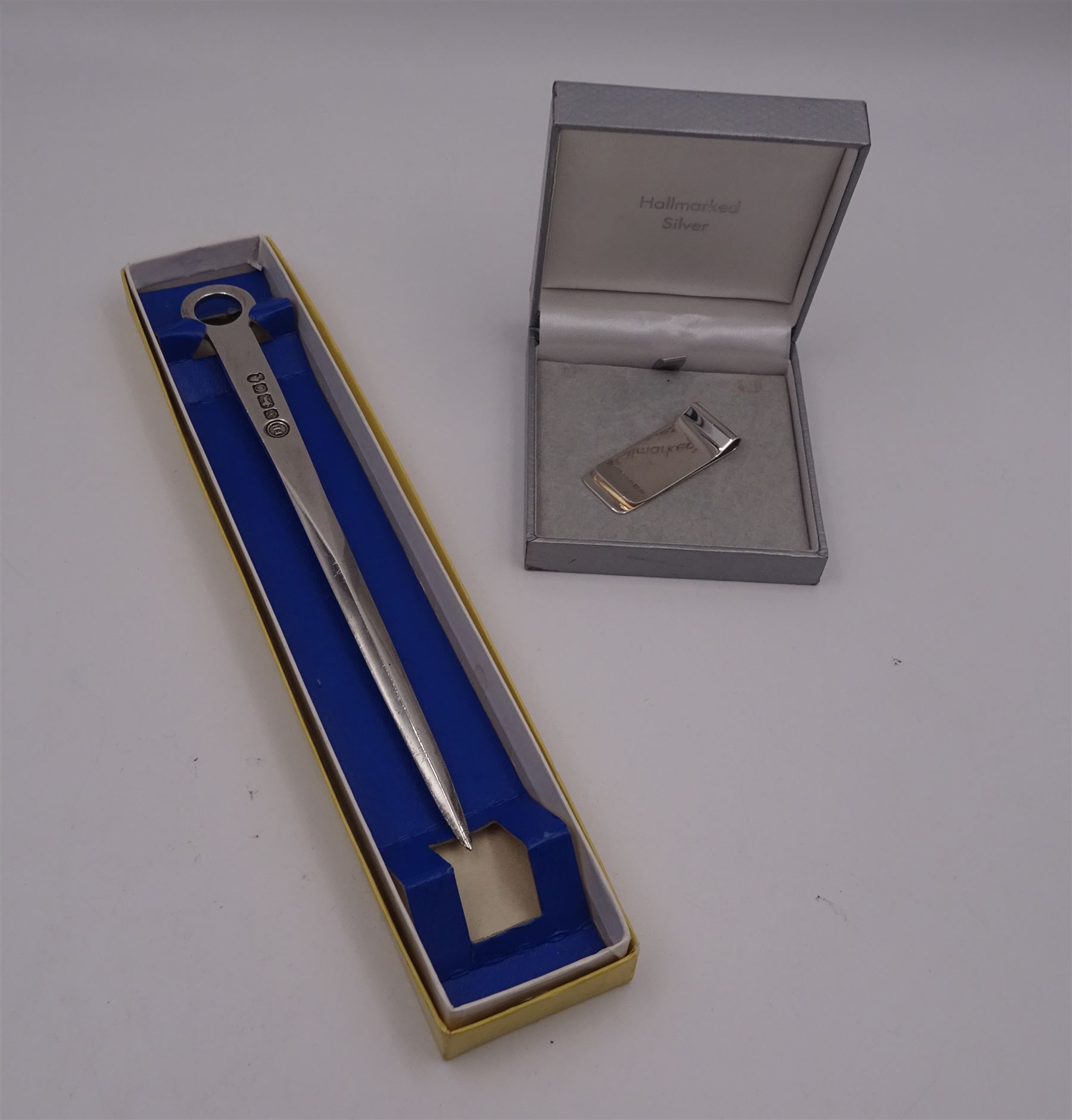 Modern silver letter opener with ring terminal, hallmarked Francis Howard Ltd, Sheffield 1977, L21.3cm, together with a modern silver money clip, of plain typical form, hallmarked W I Broadway & Co, Birmingham 2015, L5cm, each with maker's box, approximate total silver weight 2.45 ozt (76.2 grams)