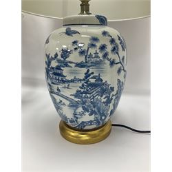 Pair of Chinese table lamps of baluster form, each decorated with landscape scene, raised upon gilt circular base, including shade H63cm