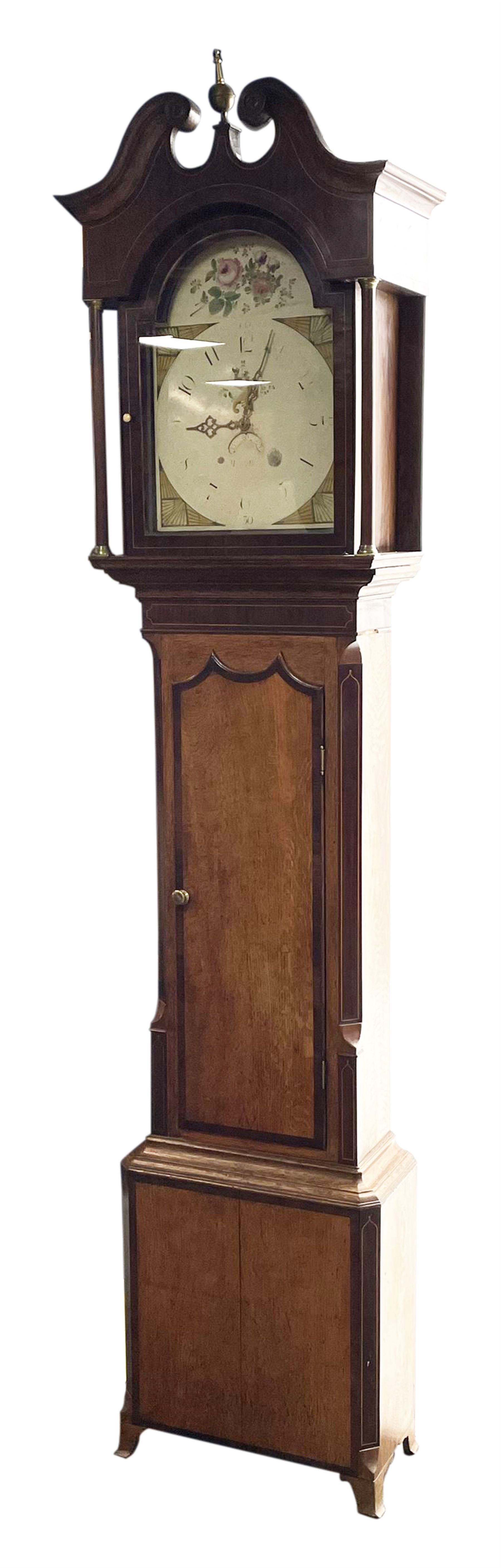 Early 19th century oak and rosewood banded longcase clock, scrolled pediment over stepped arch hood door, enamel painted dial indistinctly signed for a Penrith maker, 30-hour movement striking on bell