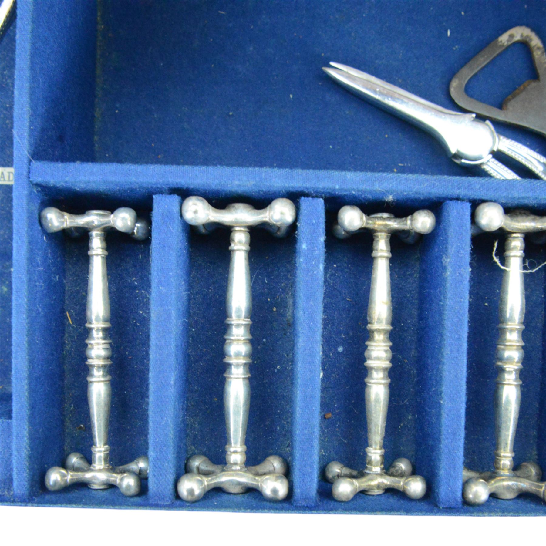 Oak table top canteen cabinet, the top with inset vacant brass cartouche, with pair of panelled doors opening to reveal four interior drawers with inset brass handle, containing a selection of silver plated flatware, 29cm x 40cm x 51cm