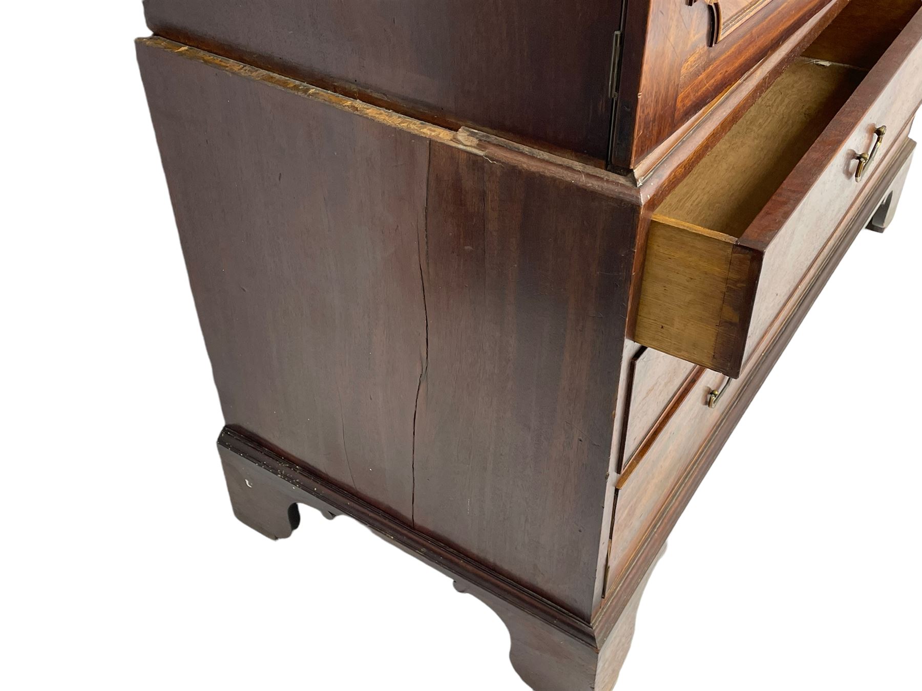 George III mahogany linen press, projecting cornice over two figured doors enclosing five linen slides, the lower section fitted with two short and two long drawers, on bracket feet