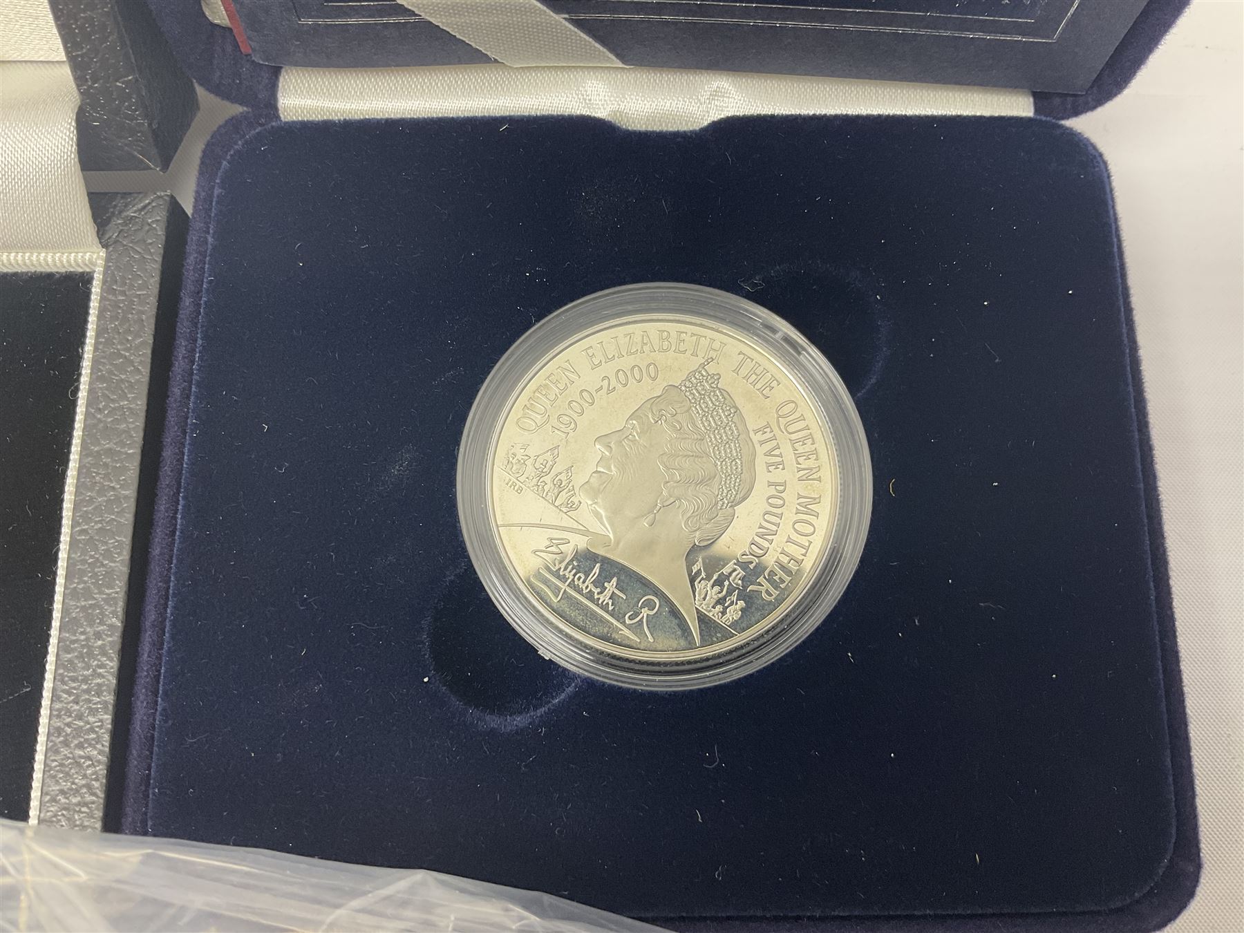 The Royal Mint United Kingdom 'Millennium' silver proof two coin set comprising 1999 and 2000 five pound coins, 2000 'The Queen Mother Centenary Year' silver proof crown, 2001silver proof one pound, 'Her Majesty The Queen Golden Jubilee 1952-2002' silver proof 2002 five pound coin and ten pound banknote set, all being cased with certificates, United Kingdom 1999 brilliant uncirculated coin collection in card folder, other commemorative coinage etc