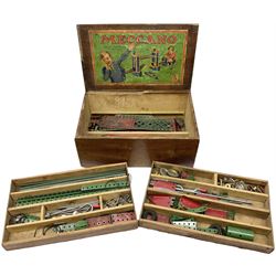 Meccano - wooden box with Set No.5 label to sliding lid, containing two lift-out trays and bottom layer of predominantly red and green sections, wheels, pulleys, rods, tyres etc, carrying handles to either end, L36cm D22.5cm H13.5cm