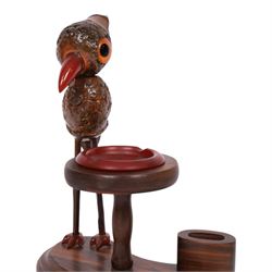 Henry Howell & Co., YZ bird novelty smokers stand, circa 1920-30's, with novelty nut bird with Bakelite beak and tail, with removable Bakelite ashtray on raised wooden plinth, with match holder and striker to the base, stamped YZ TRADE MARK MADE IN ENGLAND to base, 23cm, L21cm  