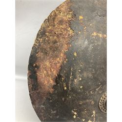 Indian black lacquered hide shield/dhal, of circular convex form fitted at its centre with four pierced iron bosses, each of hemispherical form with wide brims, the bosses corresponding on the inside with four iron rings for enarmes D53.5cm