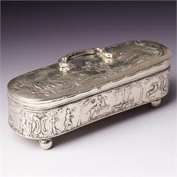 19th century continental silver box of oval design , the hinged cover with swing handle embossed with sailing ships, castle etc, the base decorated with horse and cart in rural landscape and the sides with a hunting scene on ball feet L15cm