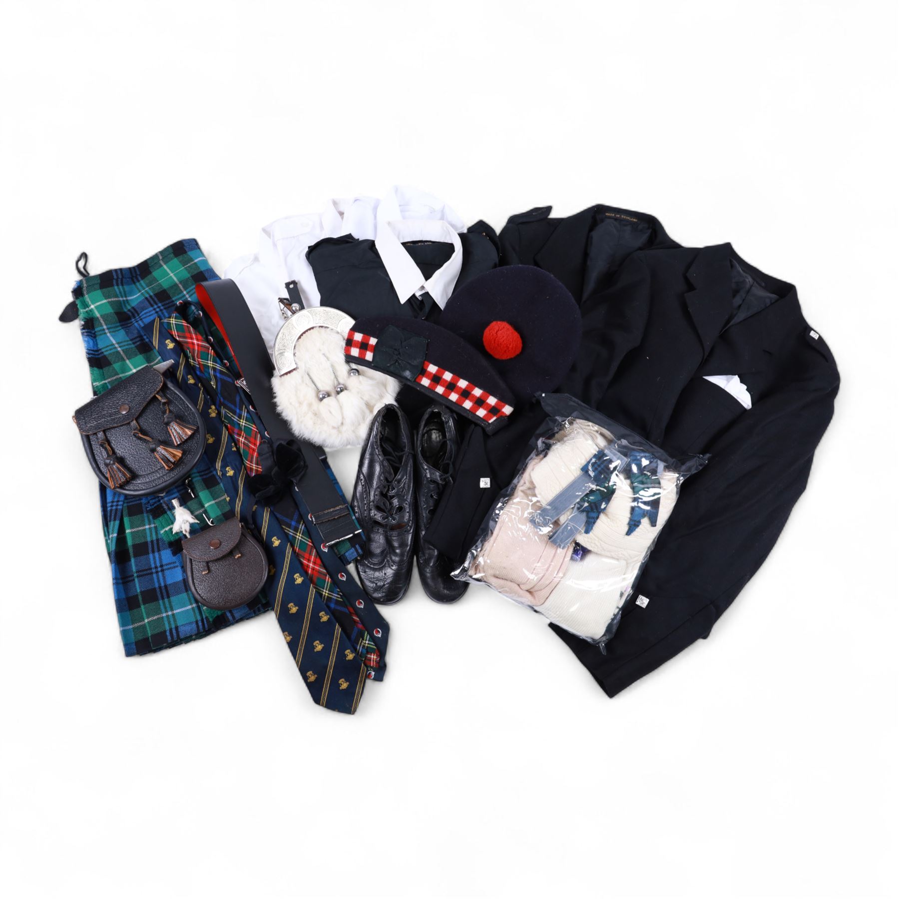 Piping regalia, comprising Armstrong tartan kilt with two kilt pins, three sporrans, including fur example, two jackets, Glengarry hat, other hats, collection of shirts, socks, ties, Hecsan shoes, dirk and belt