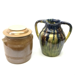 A large drip glaze stoneware twin handled vessel, of ovoid form with a merging blue, brown and green glaze, with impressed mark beneath, H30.5cm, together with a large French brown glaze stoneware storage jar and reversible cover, marked to cove Made In France, H24cm. 