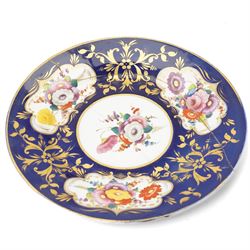 Collection of early 19th century Coalport pattern tea ware decorated with panels of flowers within a blue and gilt surround comprising eight tea cups, three coffee cups, eight saucers, four large plates, two handled sucrier and cover, milk jug and slop bowl and a similar small dish with loop handle