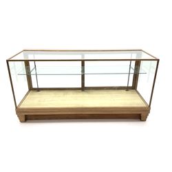 Mid century oak framed glazed display counter, two sliding doors, glazed shelves W182cm, H91cm, D61cm