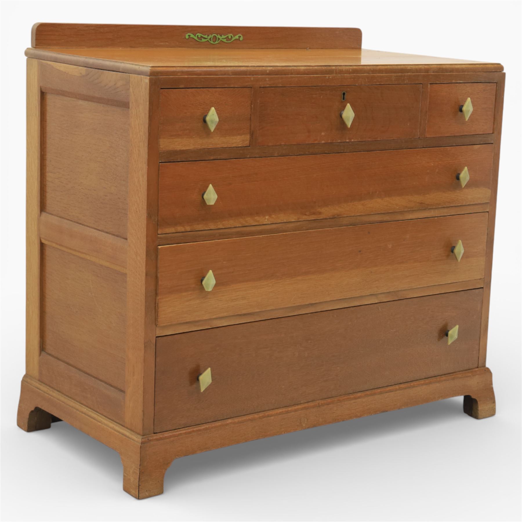 Early 20th century Art Deco bedroom suite, comprising double wardrobe, dressing table and chest of drawers, constructed in walnut with figured veneers and geometric banding, the wardrobe with arched top and panelled doors enclosing a fitted interior, the dressing table with rectangular top below a three panel mirror arrangement, fitted with two short over two long drawers, the chest with three short and three long drawers, each piece fitted with faceted handles and raised on shaped feet
Wardrobe (H 177cm, D 46cm, W 112cm)
Chest (H 85cm, D 48cm, W 92cm)
Dressing table (H 160cm, D 52cm, W 106cm)
