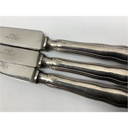 Two silver napkin rings, silver spoon with thistle top terminal, two silver handled butter knives, and small glass jar with silver cover, all hallmarked, approximate weighable silver 53.7 grams