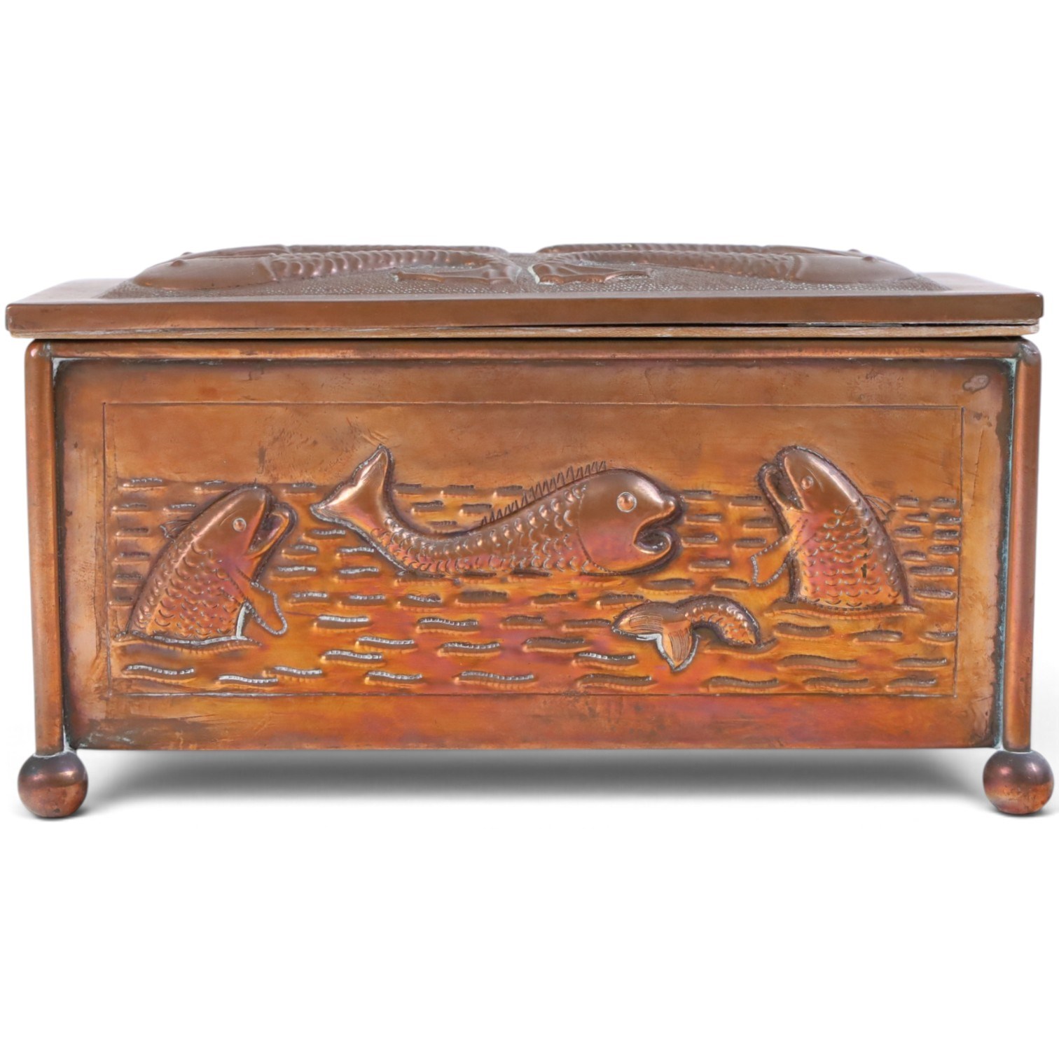 Art and Crafts copper and brass hammered casket, of rectangular form with repoussé decoration of dolphins, in the manner of  John Pearson, H10cm L19cm