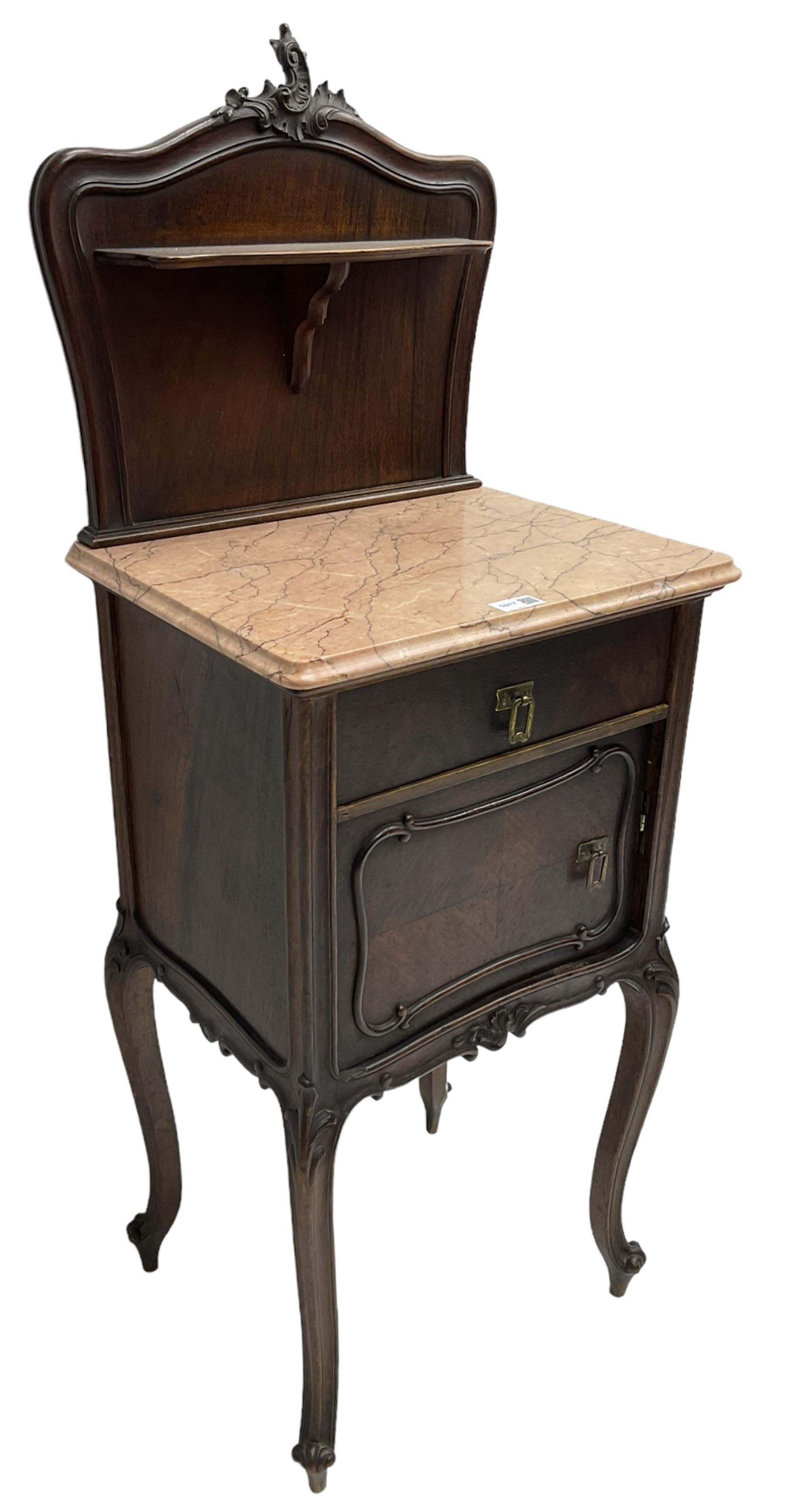 Late 19th to early 20th century walnut bedside pot cupboard, the shaped raised back with carved C-scroll pediment, pink variegated marble top, fitted with single drawer and cupboard, foliage carved cabriole supports with scroll carved terminals