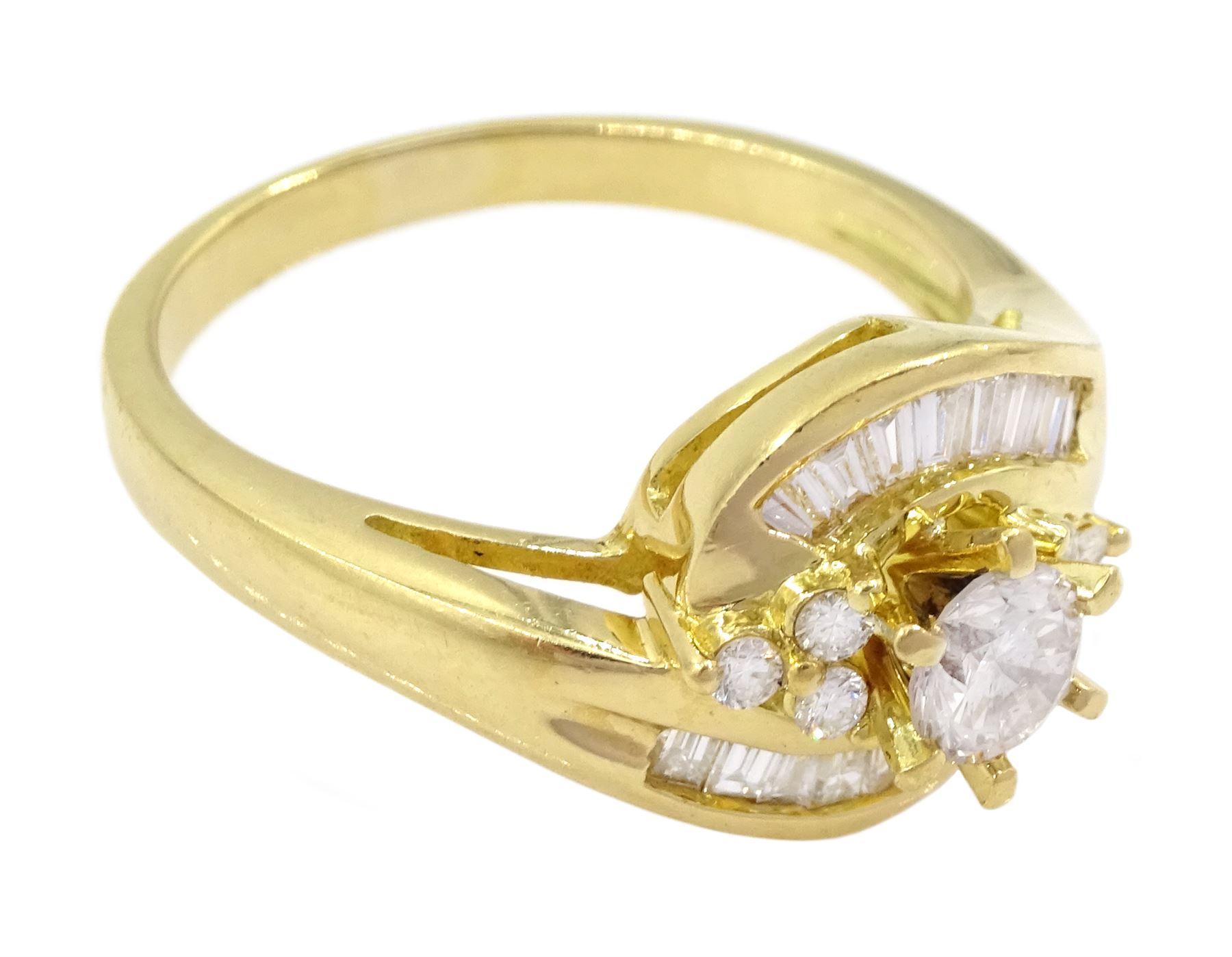 18ct gold diamond crossover ring, the central round brilliant cut diamond of approx 0.45 carat, with round brilliant and tapered baguette cut diamond surround, total diamond weight approx 1.00 carat