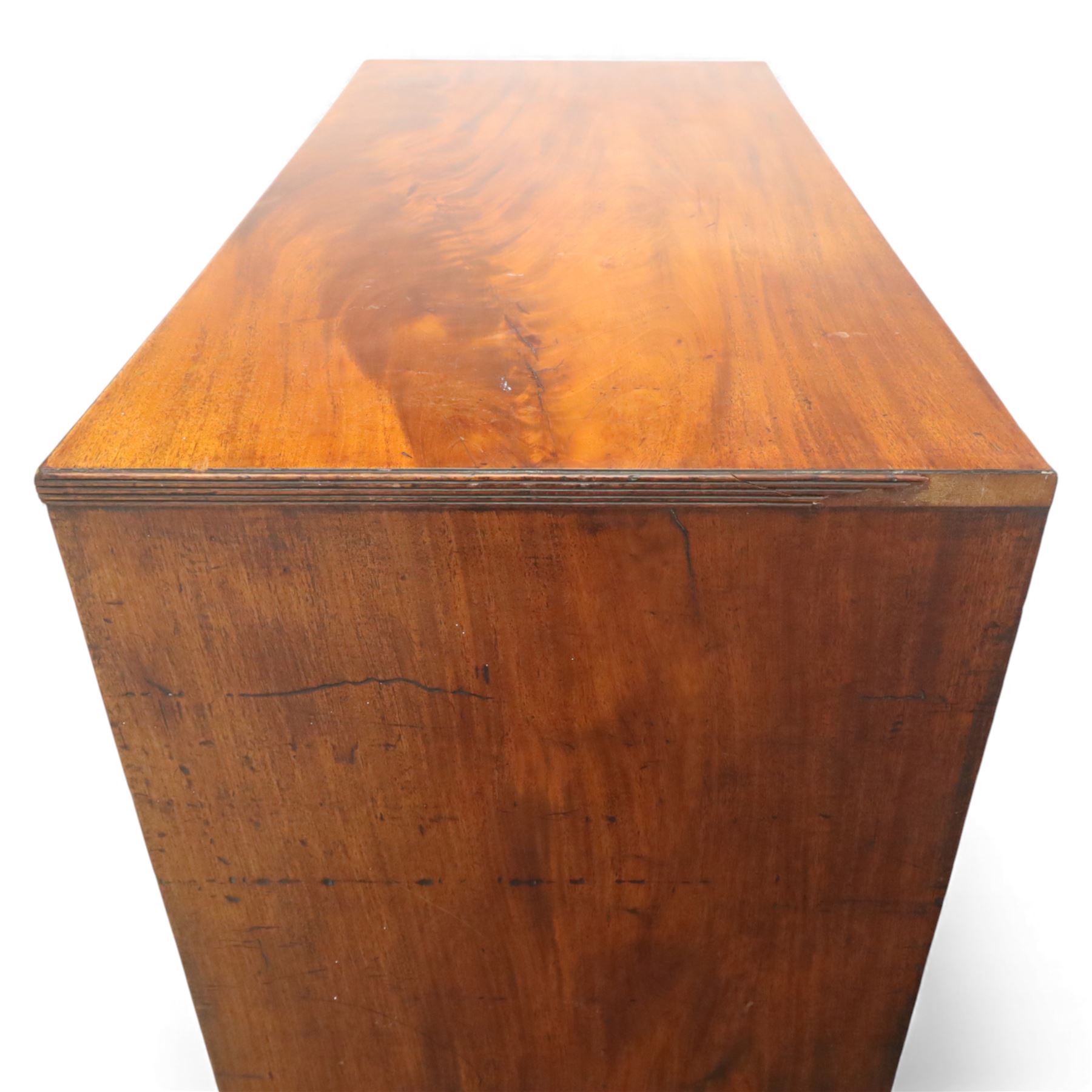 Early 19th century mahogany secretaire chest, the rectangular top over a fall-front fitted with pigeonholes and small drawers, above two long drawers with turned wooden knobs, upon swept bracket feet