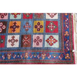 Persian Gabbeh indigo ground runner rug of garden design, the multi-coloured field decorated with five columns of panels in contrasting colours with stylised plant motifs, the guard band with trailing foliage