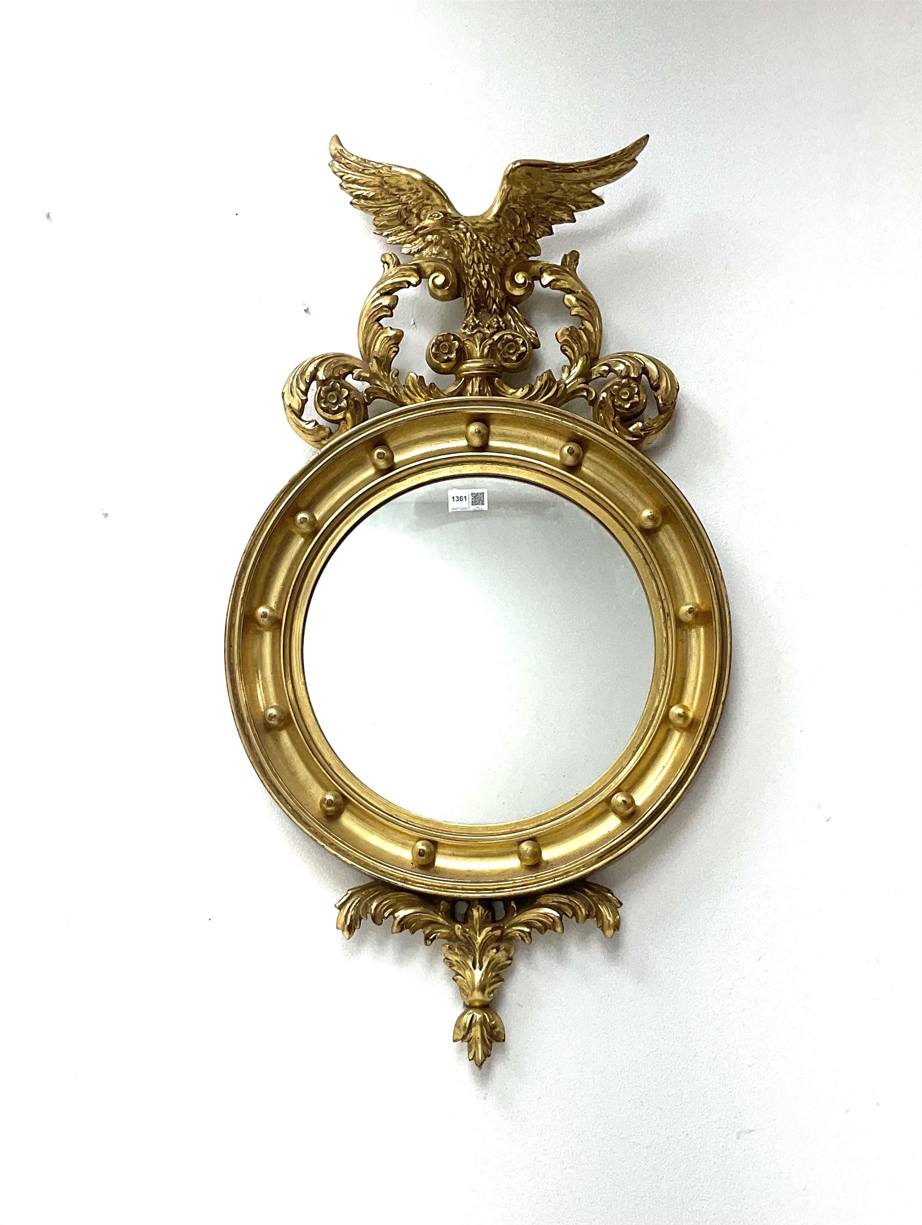 Reproduction Regency style gilt wall mirror, the eagle and leaf scroll pediment over circular mirror plate