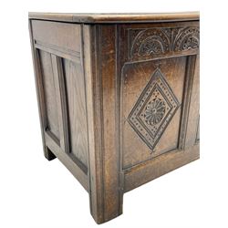 18th century oak coffer or chest, rectangular triple panelled hinged top with moulded edge enclosing main compartment and candle box, the frieze carved with repeating concentric lunettes and foliate patterns, the front fielded panels decorated with lozenges containing central flower heads, on stile supports