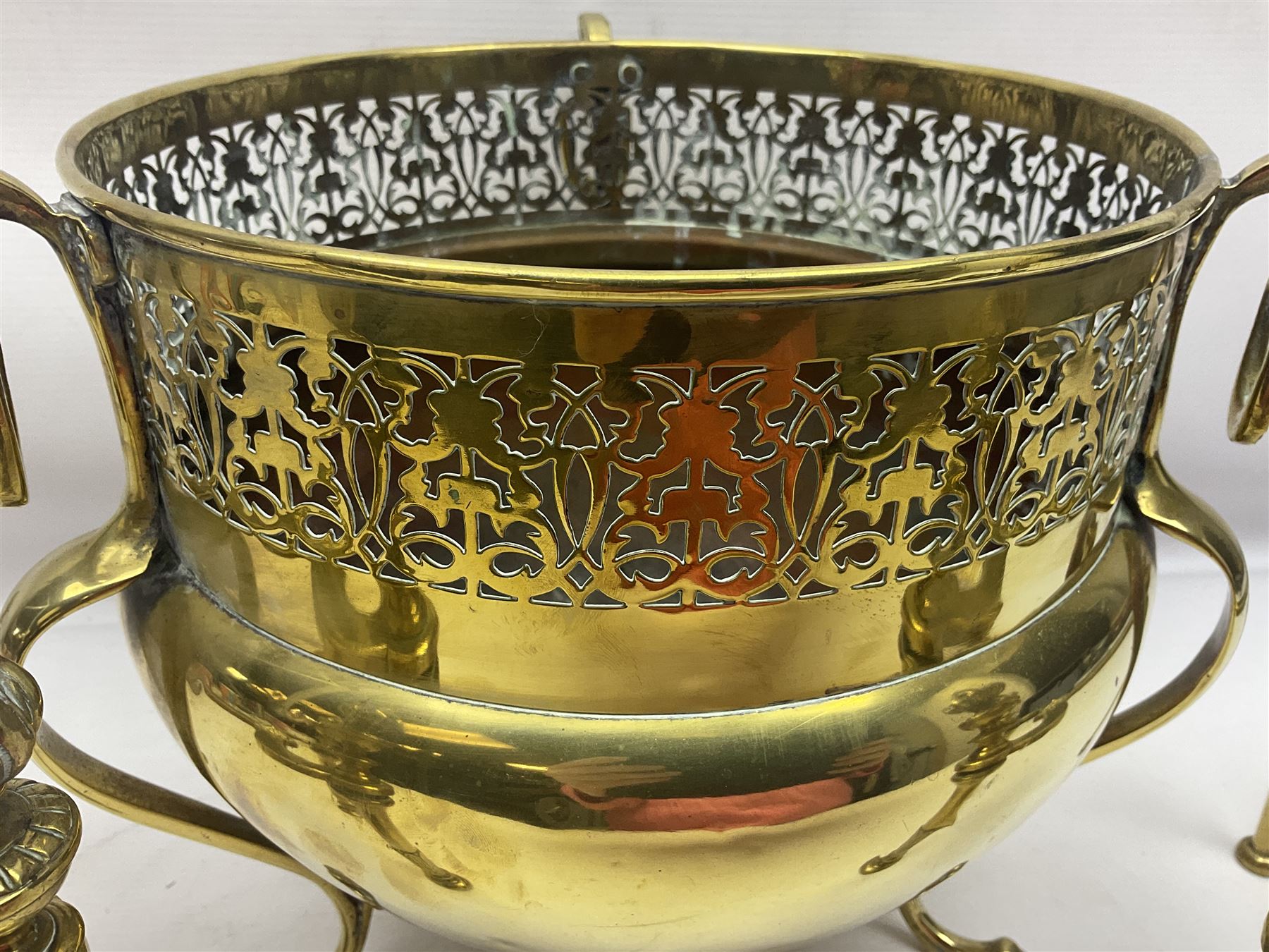 Early 20th century brass coal bucket with pierced sides, upon three pad feet, together with a pair of brass fire dogs, with flambe finials, coal bucket H27cm