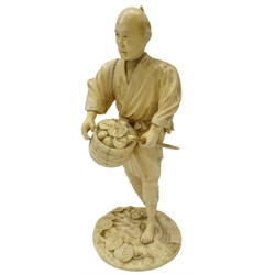  Japanese Meiji period carved ivory figure of a Farmer dressed in a robe, holding a basket and stick, signature to base, H21cm   
