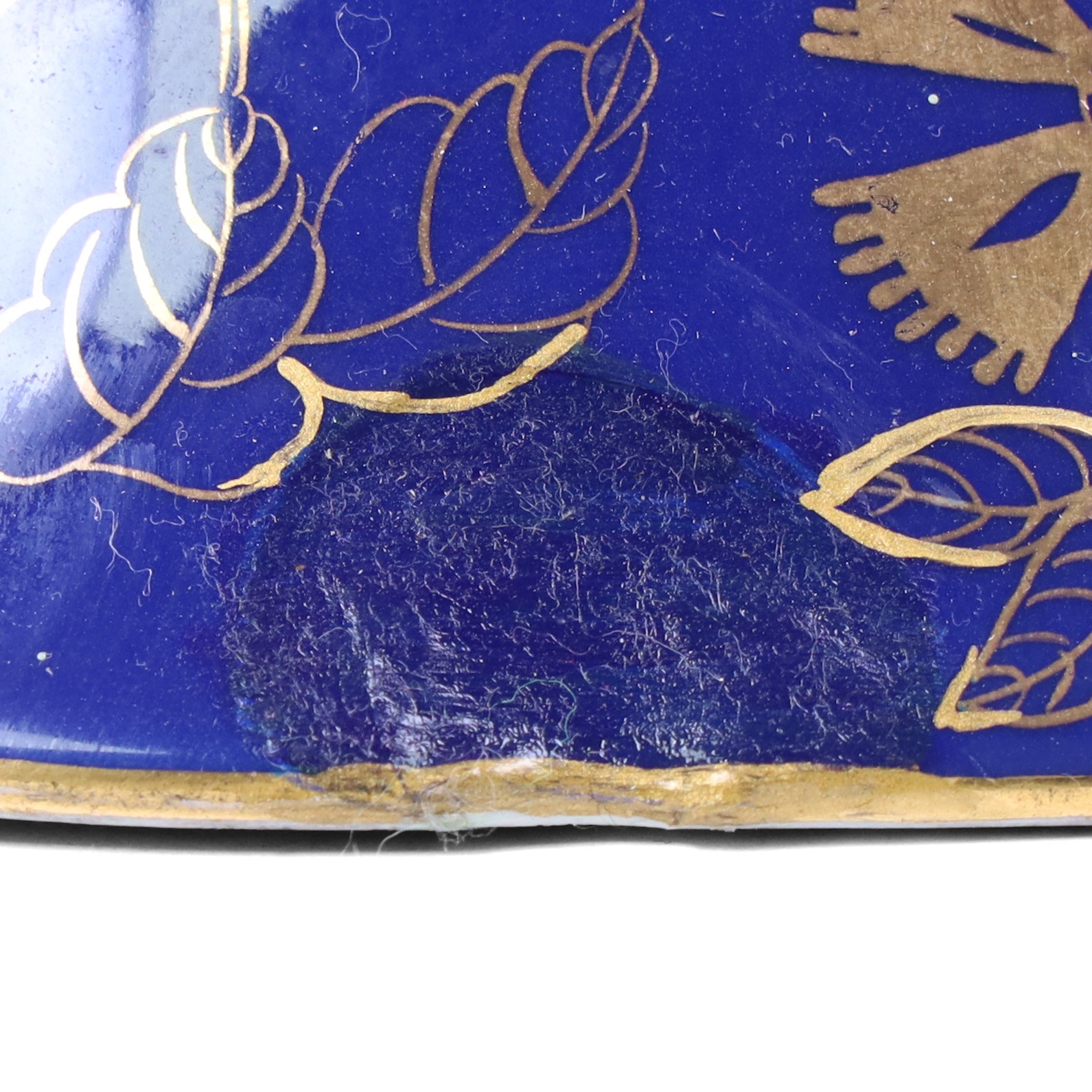Pair of 20th century foo dog incense burners, decorated with gilt flowers and insects upon a blue ground, on wooden stands, H58cm 