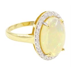14ct gold opal and diamond cluster ring, single cabochon cut opal of approx 2.80 carat, with round brilliant cut diamond surround, stamped, total diamond weight approx 0.35 carat