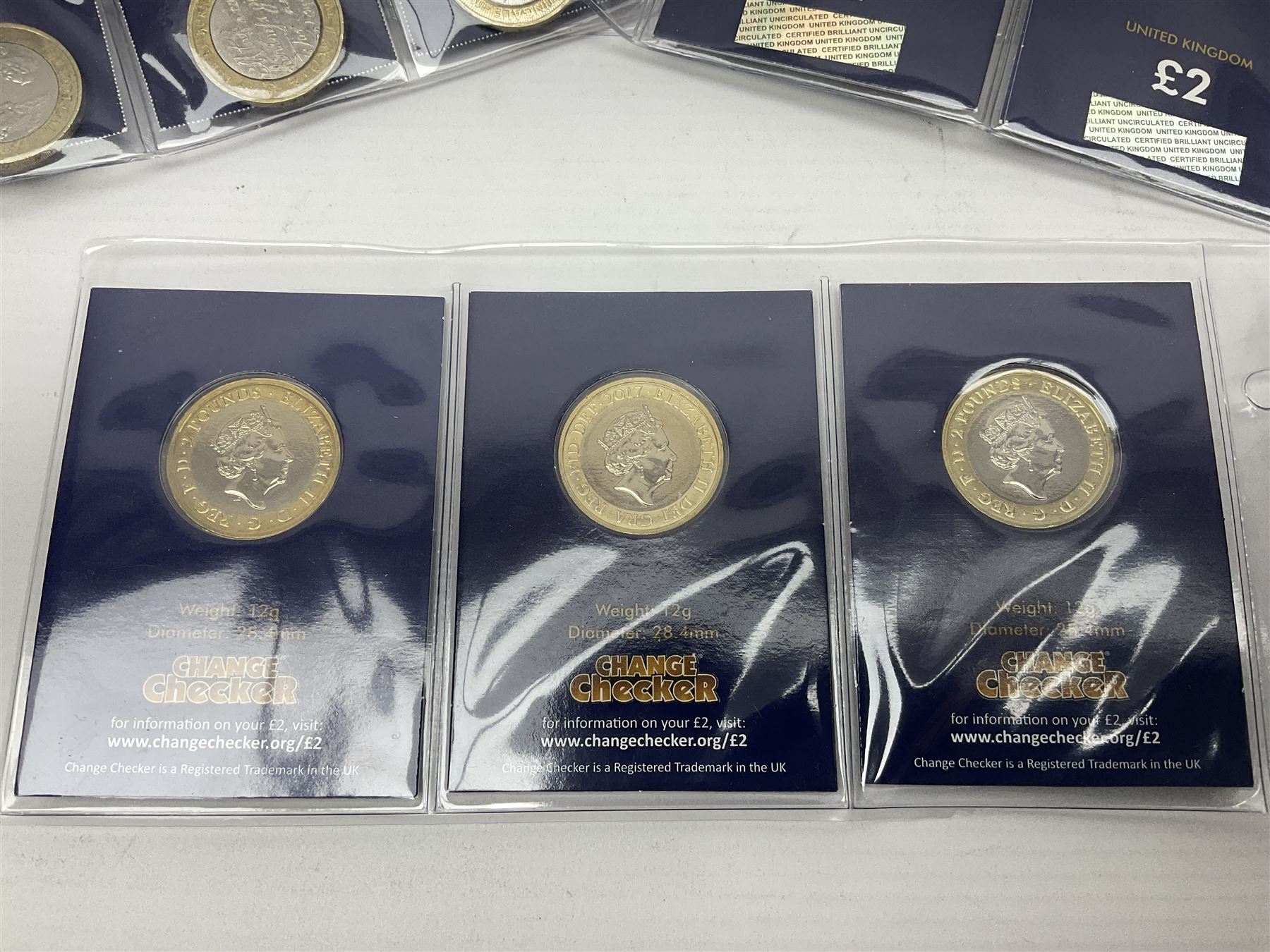 Mostly United Kingdom Queen Elizabeth II commemorative two pound  coins, including 2017 'Jane Austen', 2018 'Sea King', 2018 'Vulcan' etc face value of UK coins approximately 98 GBP