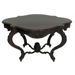 19th century Irish rosewood centre table, the shaped and moulded top over shaped apron carved with scrolled foliage, on serpentine supports carved with bell flowers, the supports united by anthemion carved finial and s-scroll x-framed stretchers
