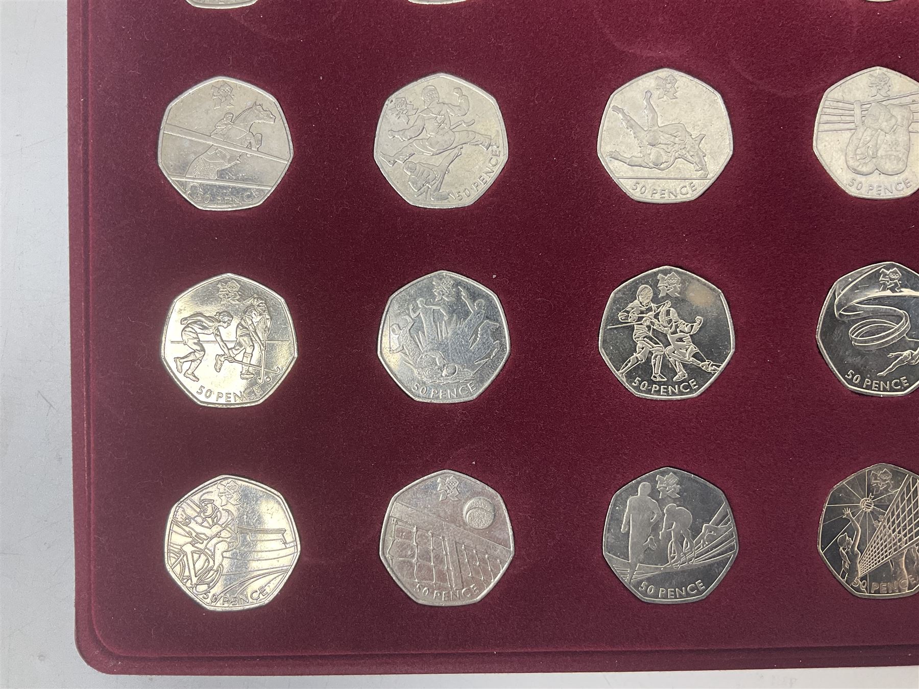 Queen Elizabeth II United Kingdom London 2012 Olympic commemorative fifty pence collection comprising twenty-nine coins and completer medallion, housed in unofficial display case