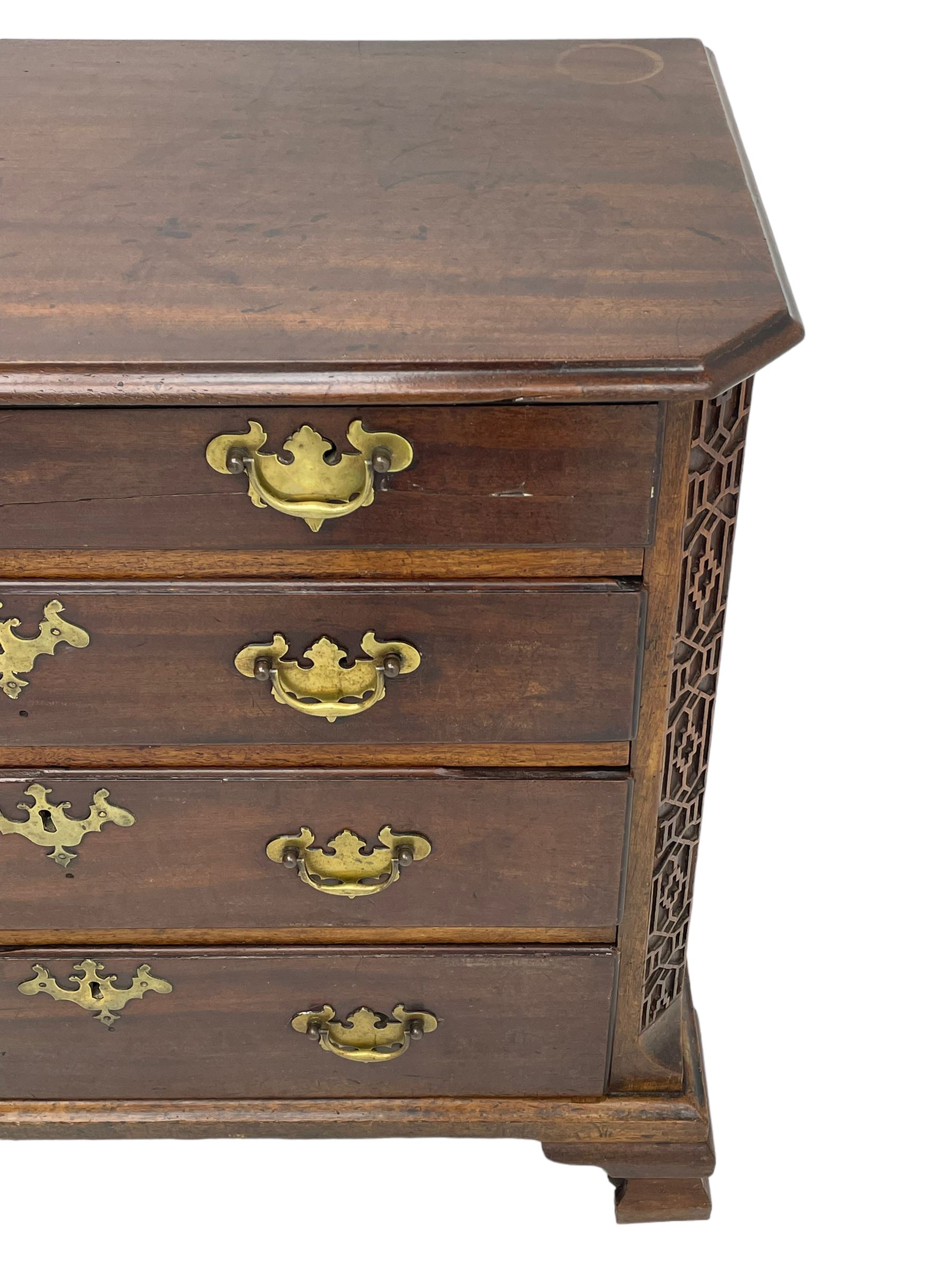 George III Chippendale design mahogany chest, moulded rectangular top with canted corners, wide canted uprights with blind fretwork decoration, two short and three long with moulded fronts, shaped brass handle plates, on ogee bracket feet 