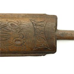 19th century oak mangle board, incised date 1864, decorated with a flower emerging from a pot, W51cm 