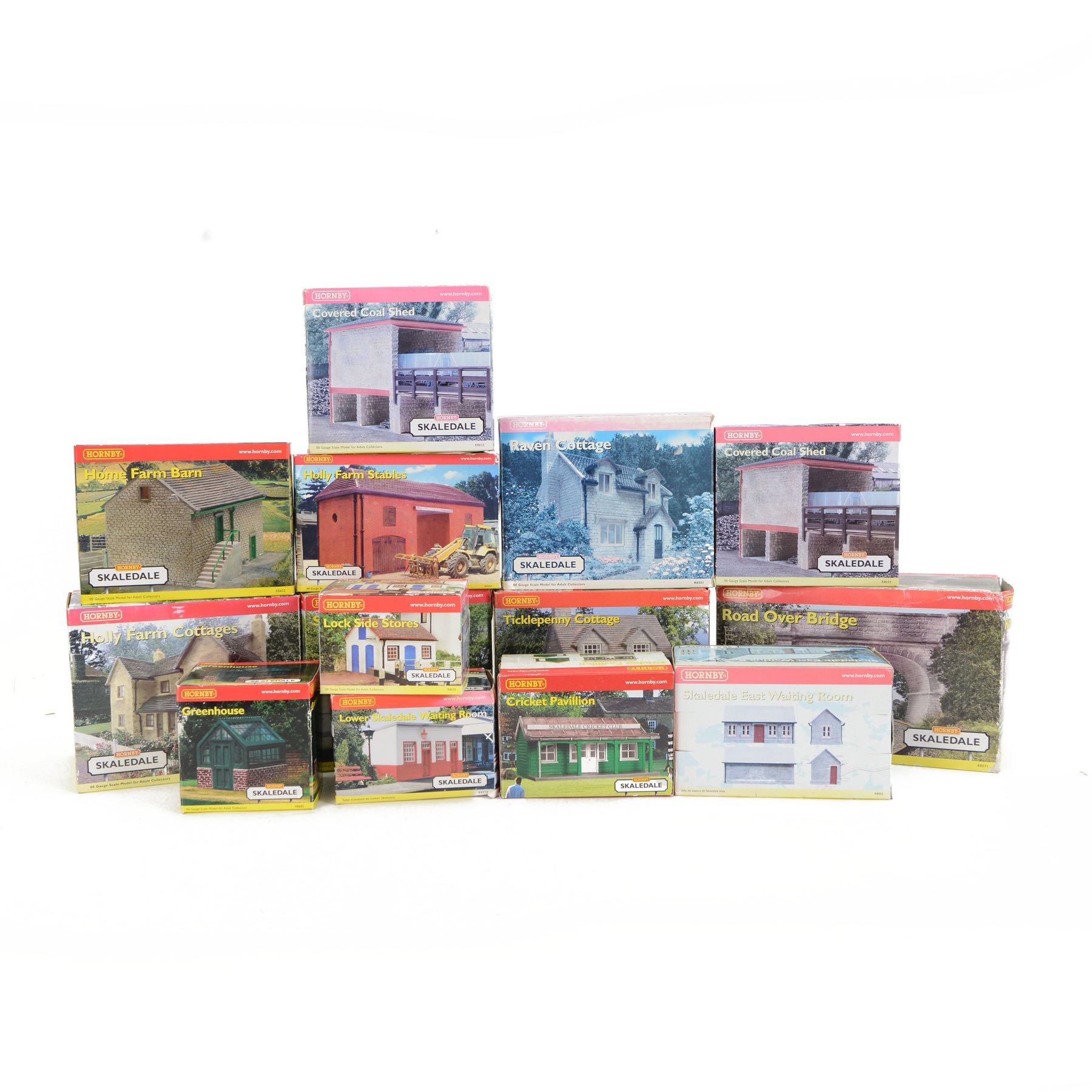 Fourteen Hornby Skaledale 00 gauge model railway trackside buildings, comprising R8504 Holly Farm Cottages, R8501 Ravenn Cottage, R8655 Lock Side Stores, R8550 Ticklepenny Cottage, R8719 Lower Skaledale Waiting Room, R8602 Holly Farm Barn, two R8633 Covered Coal Shed, R8525 Holly Farm Stables, R8629 Station Building, R8571 Road Over Bridge, R8856 Skaledale East Waiting Room, R8990 Cricket Pavillion and R8682 Greenhouse, all boxed