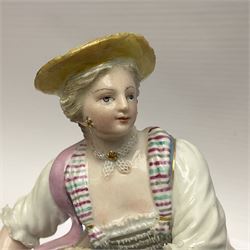 Pair of late 19th/early 20th Century Meissen figures, modelled as flower sellers, after the original by Michel Victor Acier, she holding basket of flowers, he holding flowers in his hat, each with underglaze cross swords mark beneath, tallest H16.5cm