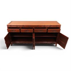 20th century Chinese ornately hardwood sideboard, rectangular top over four drawers above four cupboards, pierced carved apron, raised on cabriole legs 