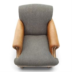 Tetrad - 'Taransay' Harris Tweed and tan leather club armchair, Howard shape with reclined back over deep seat and rolled arms with studwork, raised on turned front supports with castors, the sides and arms upholstered in tan leather with seat and back in herringbone-stitched Harris Tweed