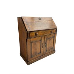 19th century waxed pine bureau, the fall front opening to reveal fitted interior with two drawers and five pigeonholes, base with single drawer over two panelled cupboard doors, on plinth base