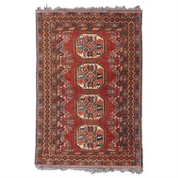 Afghan red ground rug, the field decorated with stylised plant motifs, within multiple borders (137cm x 105cm); together with a Caucasian red ground rug decorated with three Gul motifs (123cm x 85cm)