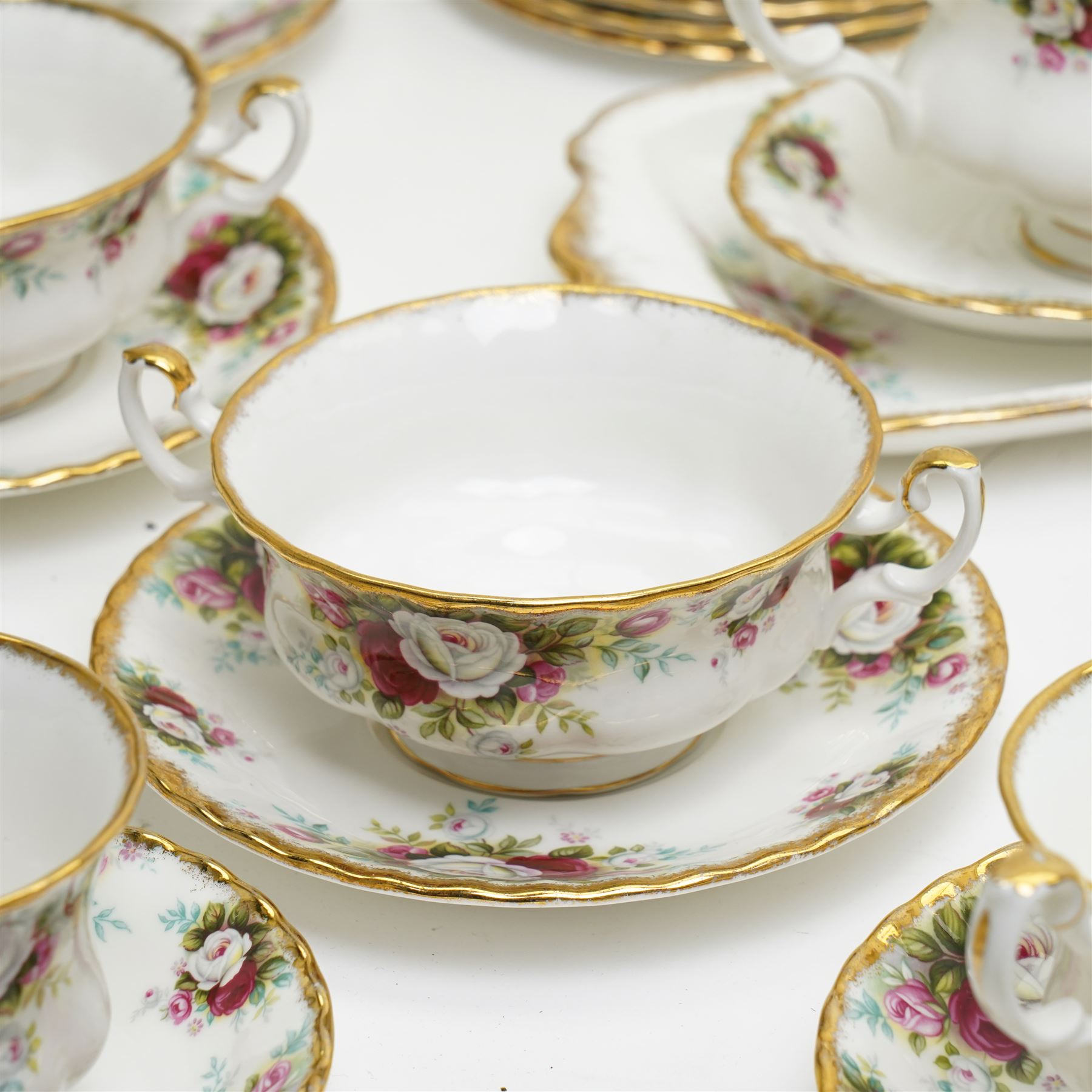 Royal Albert Celebration pattern tea and dinner wares, comprising covered tea and coffee pot, seven dinner plates, oval serving dish, gravy boat and saucer, nine coffee cups and ten coffee cup saucers, seven teacups and eight teacup saucers, eight soup bowls and saucers, rectangular serving tray, ten side plates, etc, approximately 88 pieces in total