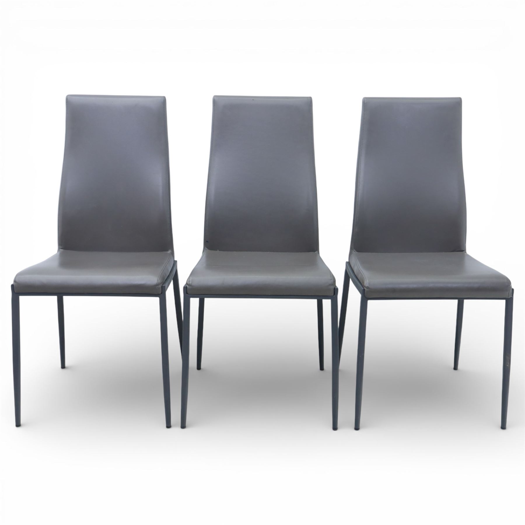 Modern composite marble effect dining table, rectangular top with simulated veining supported on a block pedestal base, accompanied by six matching dining chairs with padded seats and backs in grey upholstery on slim metal legs