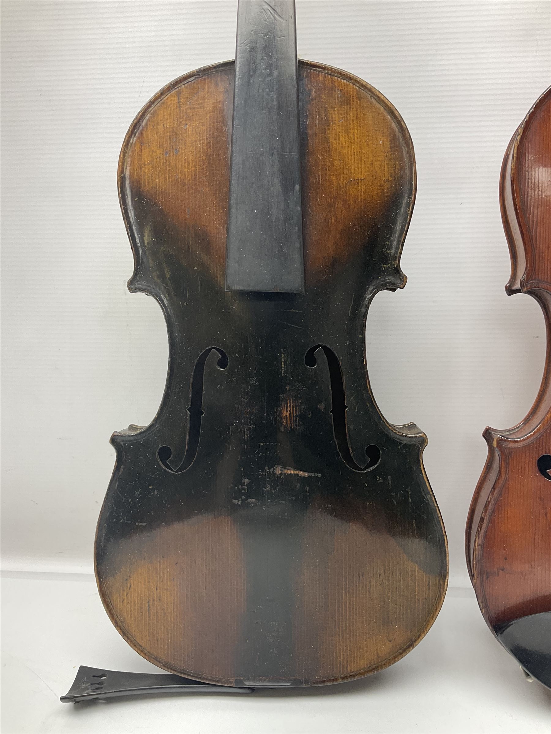 German violin c1890 with 36cm two-piece maple back and ribs and spruce top; bears label 'Antonius Stradivarius Cremona Faciebat Anno 1729' L59.5cm overall; in ebonised wooden 'coffin' case; and two German violins c1890 for completion - one bearing a Stradivarius label, the other a Ruggeri label; both in carrying cases (3)