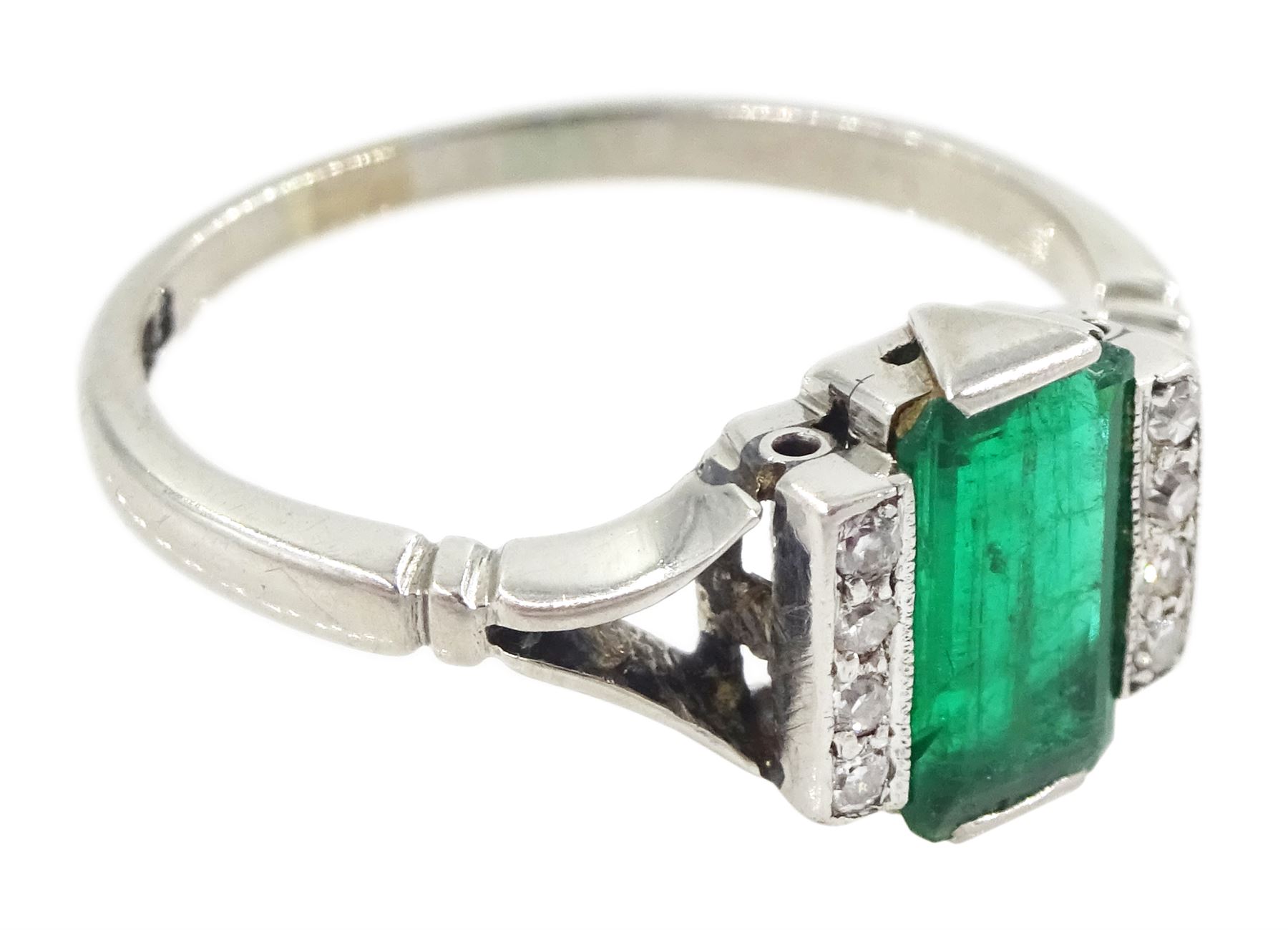 Early 20th century platinum emerald cut emerald and eight stone single cut diamond ring, stamped PT, emerald approx 0.70 carat