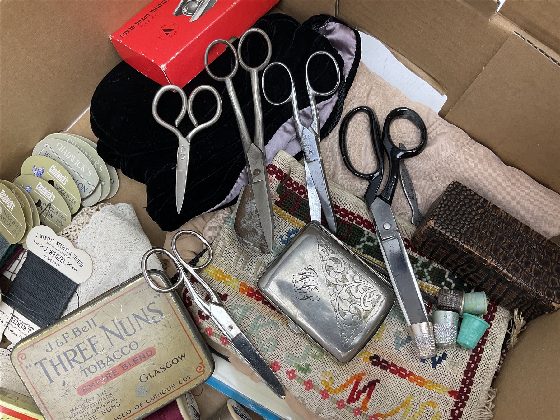  Victorian sampler worked with the alphabet by Carrie Monkman 1886, Victorian silver-plated cigarette case, Carlo simulated tortoiseshell motorised fan in case, Folding Opera Glasses, two chrome leaping Jaguar brooch and matching pin badge, quantity of sewing threads, lace etc