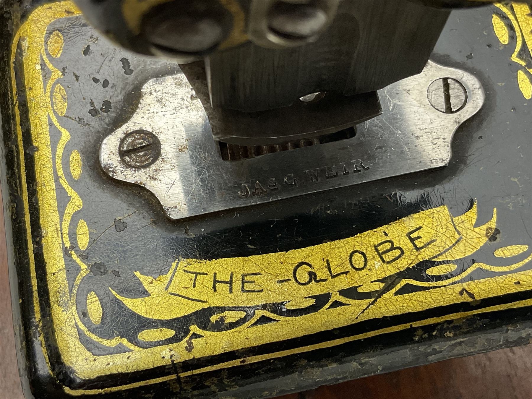 James G Weir 'The Globe' hand-cranked sewing machine, circa 1872, in black finish with gilt and flower painted decoration, the bed stamped Ja's G. Weir, 2 Carlisle Street, Soho Sq., London, with walnut locking carrying case and original manual, boxed H25cm 