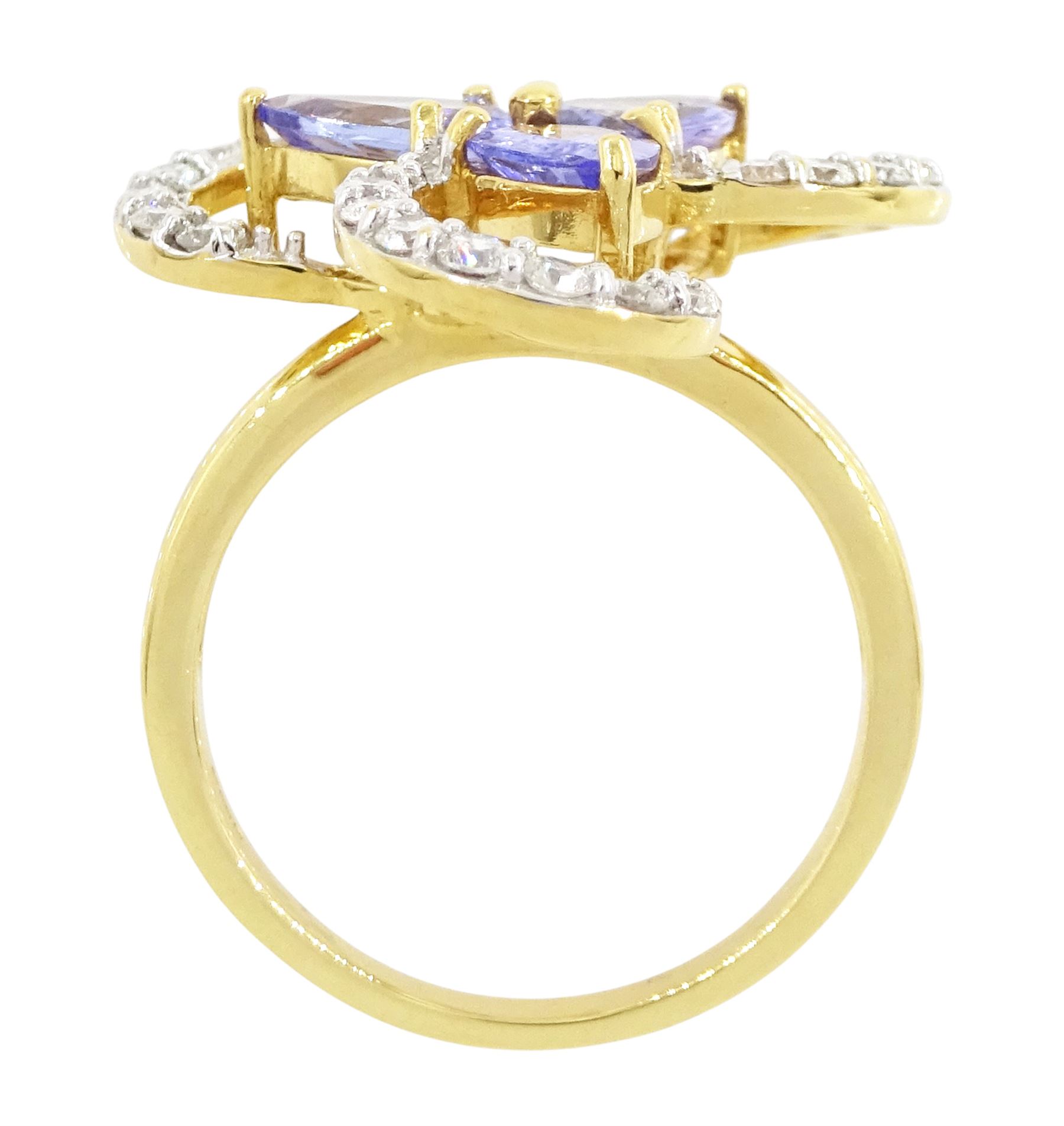 18ct gold tanzanite and diamond cluster ring, three pear cut tanzanite's, with round brilliant cut diamond surround, in an openwork swirl setting, hallmarked, total tanzanite weight 1.50 carat, total diamond weight 0.55 carat, with World Gemological Institute Report